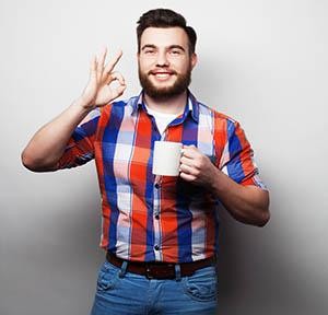 Young man smiling with coffee