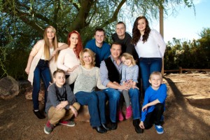 Portrait of a large family under a mesquite tree