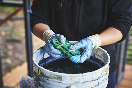 woman tie dyeing clothes