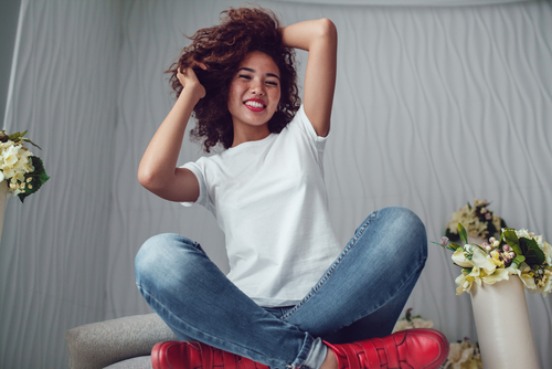 Curly haired girl with freckles in blank white t-shirt