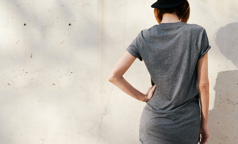 back of woman wearing loose shirt