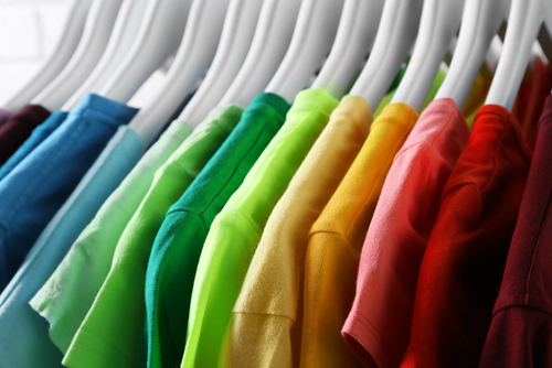 Colorful t-shirts on hangers