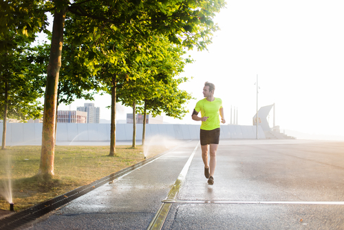 Young male jogger running on the road