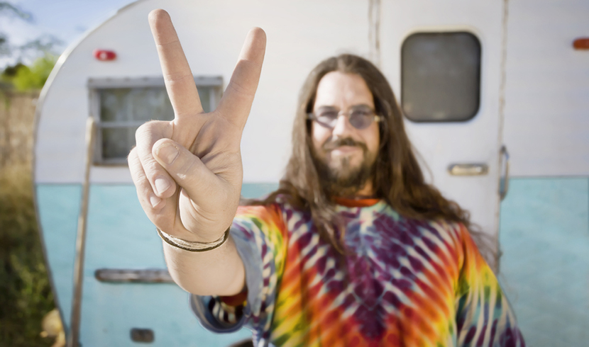 man in tie dye shirt peace sign