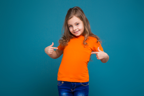 girl in orange t shirt and blue jeans