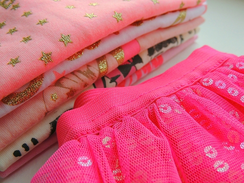 pile of toddlers pink and white clothes
