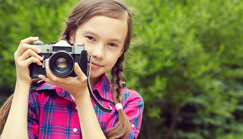 girl holding camera