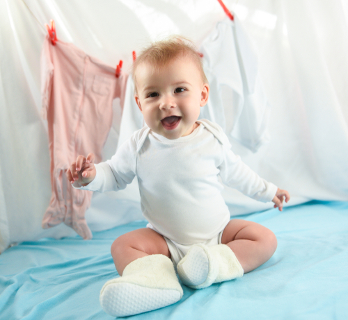 laughing baby in wearing onesie