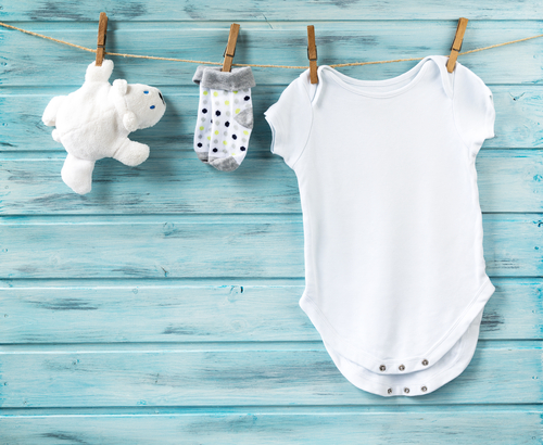 plain white onesie hanging from clothespin