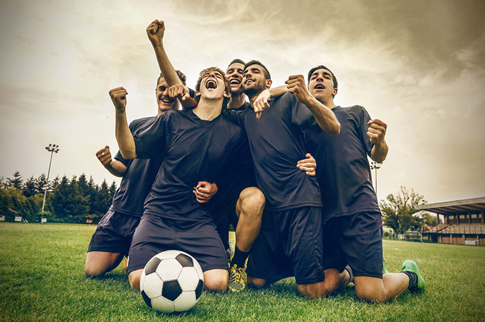 soccer team cheering together