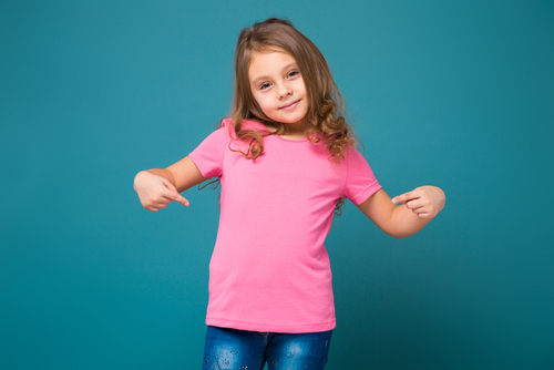 girl pointing at pink t shirt