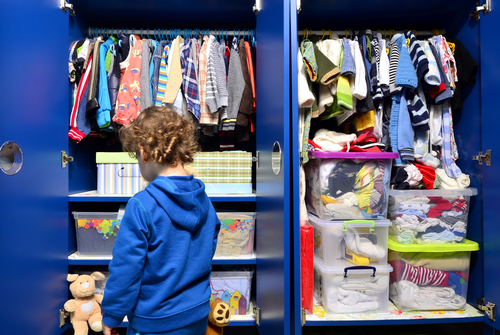 kids closet with clothes and toys