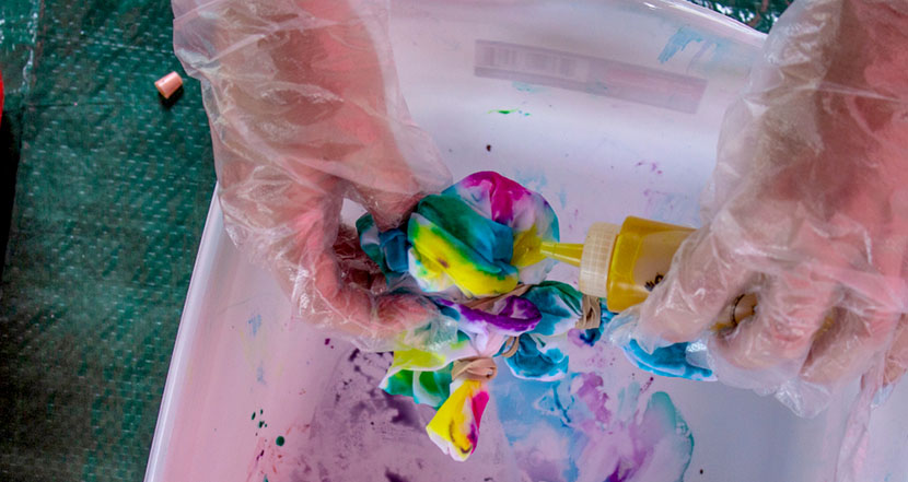 tie dyeing shirt over bucket