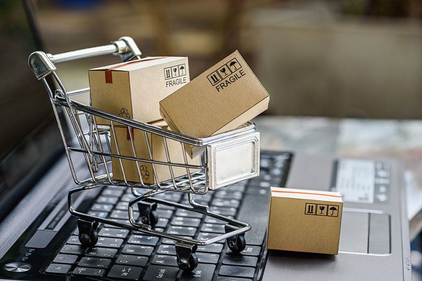 boxes in a small shopping cart on a laptop keyboard