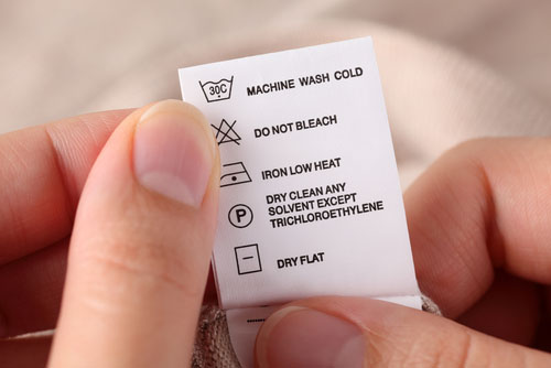 Woman's hands holding clothes label