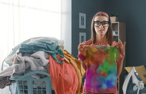 woman holding out tie dyed shirt