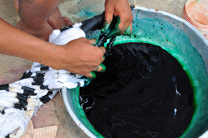 a person applying dye to a piece of fabric