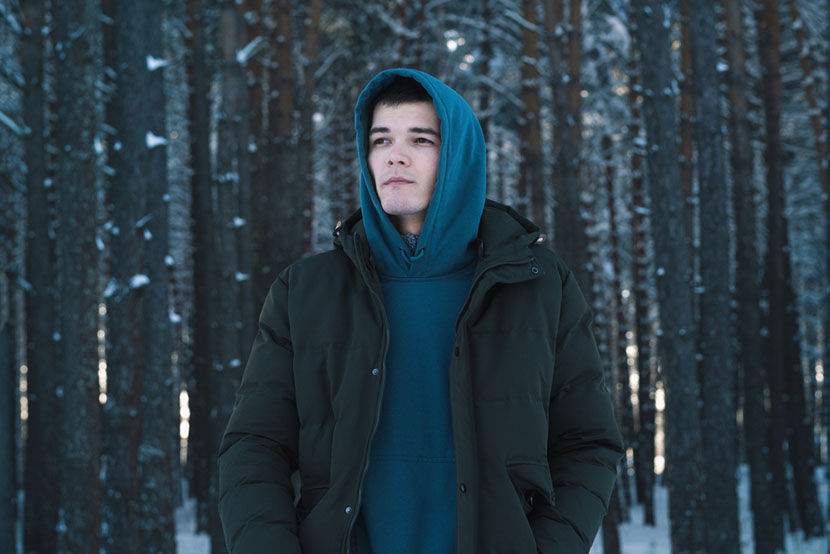 man wearing layered jackets outdoors