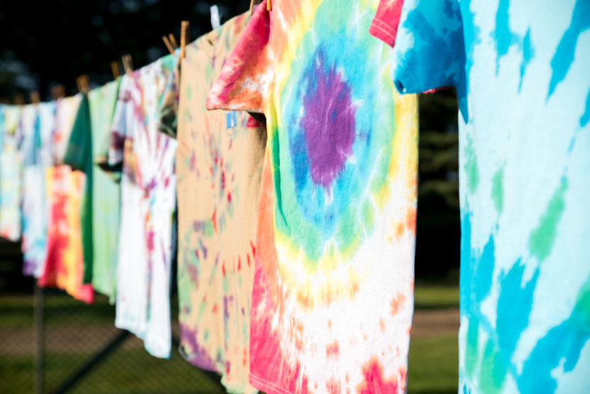 tie dyed shirts hanging on line